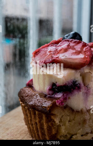 Fruit Tart Slice with strawberry and berries on wooden surface. Stock Photo
