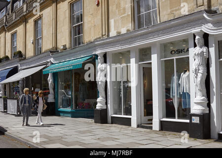 Two women walking past shops on Montpellier Walk, Cheltenham, Gloucestershire Stock Photo