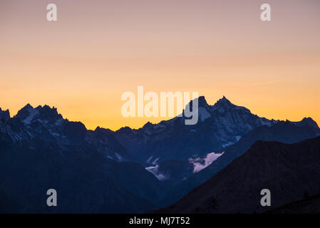 High altitude alpine landscape at dawn with first light glowing the majestic high peak of the Barre des Ecrins (4101 m), France. Stock Photo