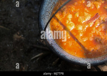 Gulyas stew boiling in a cauldron Stock Photo