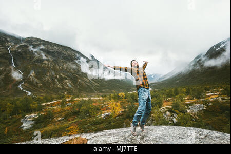 Happy man enjoying landscape view foggy forest mountains Travel adventure healthy lifestyle concept active vacations in Norway Stock Photo