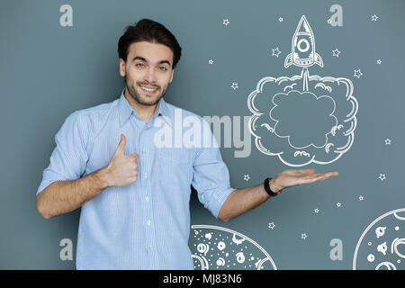 Positive engineer smiling while thinking about rocket construction Stock Photo