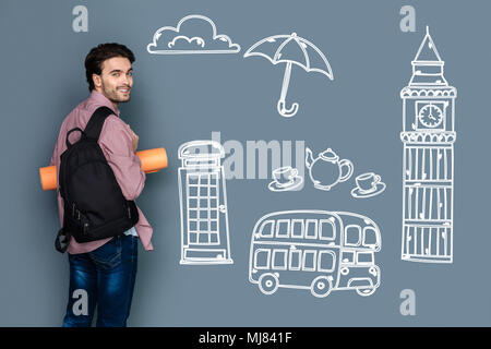 Positive experienced tourist smiling while visiting London Stock Photo