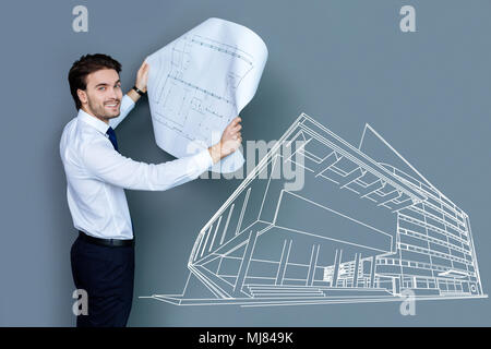 Emotional architect feeling excited while working at the new project Stock Photo