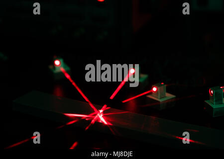 Experiment in the laboratory of Photonics with red lasers Stock Photo