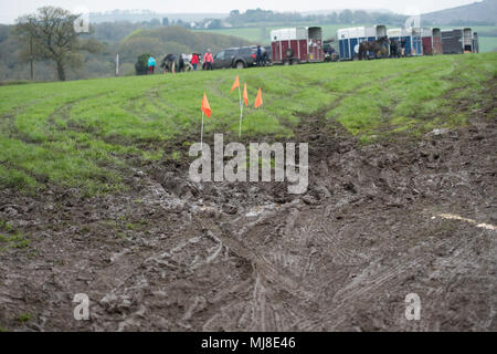 horse boxes in muddy field Stock Photo