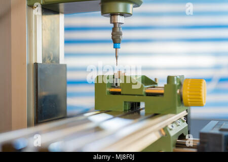 Processing of the plastic workpiece on CNC milling machine Stock Photo
