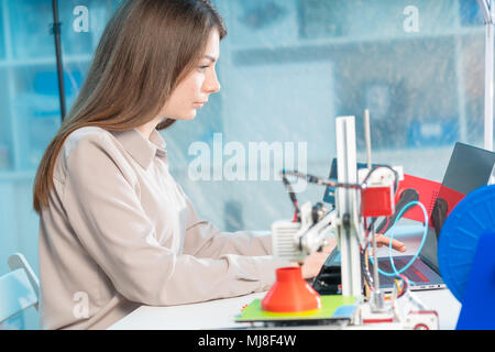 A young woman design a model of an artificial organ on a 3D printer Stock Photo