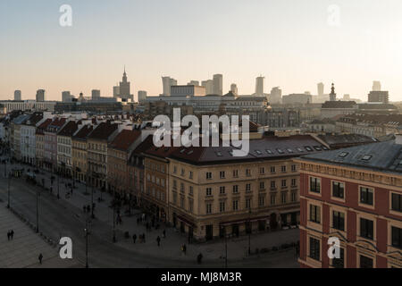 Sunset over Warsaw old town and the financial district tower in the background with the Palace of culture and science in Poland capital city Stock Photo