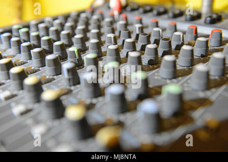 Close up of mixing desk with colourful buttons and shallow depth of field Stock Photo
