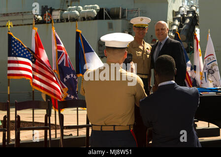 Lt. Gen. Rex C. McMillian (left), commander of Marine Forces Reserve and Marine Forces North,  and Mitch Landrieu (right), mayor of New Orleans, pose for a photo during the mayoral welcome for Navy Week at the Port of New Orleans, April 20, 2018. The celebration is an opportunity for citizens of New Orleans and surrounding area to meet service members and witness the latest capabilities of today’s maritime service. (U.S. Marine Corps photo by Lance Cpl. Melany Vasquez/Released) Stock Photo