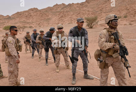 CAMP TITIN, Jordan (April 21, 2018) – U.S. Marines with Fleet Antiterrorism Security Team – Central Command and Jordanian 77th Marines Battalion stand at-the-ready while conducting live-fire exercises during exercise Eager Lion 2018, April 21.  Eager Lion is a capstone training engagement that provides U.S. forces and the Jordan Armed Forces an opportunity to rehearse operating in a coalition environment and to pursue new ways to collectively address threats to regional security and improve overall maritime security.  (U.S. Navy photo by Mass Communication Specialist 1st Class Sandi Grimnes Mo Stock Photo