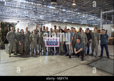 Entertainers pose for a photo with members of the 730th Air Mobility Squadron after checking out a logistics warehouse at Yokota Air Base, Japan; the first stop on the annual Vice Chairman’s USO Tour, April 22, 2018. Comedian Jon Stewart, country music artist Craig Morgan, celebrity chef Robert Irvine, professional fighters Max “Blessed” Holloway and Paige VanZant, and NBA Legend Richard “Rip” Hamilton will join Gen. Selva on a tour across the world as they visit service members overseas to thank them for their service and sacrifice. (DoD Photo by U.S. Army Sgt. James K. McCann) Stock Photo