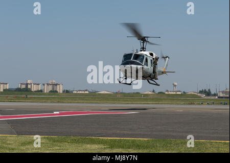 Entertainers view Tokyo city during an aerial helicopter tour aboard UH-1 Huey helicopters from Yokota Air Base, Japan; the first stop on the annual Vice Chairman’s USO Tour, April 22, 2018. Comedian Jon Stewart, country music artist Craig Morgan, celebrity chef Robert Irvine, professional fighters Max “Blessed” Holloway and Paige VanZant, and NBA Legend Richard “Rip” Hamilton will join Gen. Selva on a tour across the world as they visit service members overseas to thank them for their service and sacrifice. (DoD Photo by U.S. Army Sgt. James K. McCann) Stock Photo