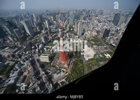 Entertainers view Tokyo city during an aerial helicopter tour aboard UH-1 Huey helicopters from Yokota Air Base, Japan; the first stop on the annual Vice Chairman’s USO Tour, April 22, 2018. Comedian Jon Stewart, country music artist Craig Morgan, celebrity chef Robert Irvine, professional fighters Max “Blessed” Holloway and Paige VanZant, and NBA Legend Richard “Rip” Hamilton will join Gen. Selva on a tour across the world as they visit service members overseas to thank them for their service and sacrifice. (DoD Photo by U.S. Army Sgt. James K. McCann) Stock Photo