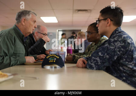 180420-N-VO895-0121 NORFOLK, Va. (April 20, 2018) --  Cmdr. (Ret.) Woody Knight eats lunch with Sailors aboard amphibious assault ship USS Bataan (LHD 5) during a tour of the ship and commemoration of 76th Battle of Bataan and Bataan Death March anniversary. Bataan is moored at BAE Systems Norfolk Ship Repair conducting a scheduled maintenance availability. (U.S. Navy Photo by Seaman Danilo Reynoso) Stock Photo