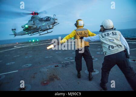 180421-N-VR594-0252 PACIFIC OCEAN (April 21, 2018) An AH-1Z Cobra assigned to Marine Light Attack Helicopter Squadron (HMLA) 267 departs the flight deck of the Harpers Ferry-class amphibious dock landing ship USS Pearl Harbor (LSD 52) during deck landing qualifications. Pearl Harbor is currently underway off the coast of Southern California conducting routine training operations. (U.S. Navy photo by Mass Communication Specialist 3rd Class Kelsey J. Hockenberger/Released) Stock Photo