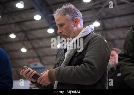 Entertainers check out a 51st Fighter Wing A-10 at Osan Air Base, Republic of Korea; the second stop on the annual Vice Chairman's USO Tour, April 23, 2018. Comedian Jon Stewart, country music artist Craig Morgan, celebrity chef Robert Irvine, professional fighters Max “Blessed' Holloway and Paige VanZant, and NBA Legend Richard “Rip' Hamilton will join Gen. Selva on a tour across the world as they visit service members overseas to thank them for their service and sacrifice. (DoD Photo by U.S. Army Sgt. James K. McCann) Stock Photo