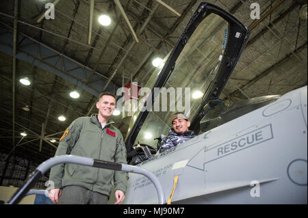 Entertainers check out a 51st Fighter Wing F-16 at Osan Air Base, Republic of Korea; the second stop on the annual Vice Chairman's USO Tour, April 23, 2018. Comedian Jon Stewart, country music artist Craig Morgan, celebrity chef Robert Irvine, professional fighters Max “Blessed' Holloway and Paige VanZant, and NBA Legend Richard “Rip' Hamilton will join Gen. Selva on a tour across the world as they visit service members overseas to thank them for their service and sacrifice. (DoD Photo by U.S. Army Sgt. James K. McCann) Stock Photo