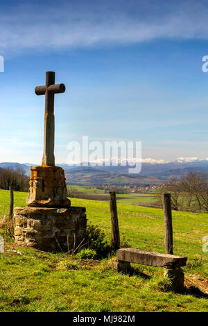 Stone path cross and view on Sancy Massif in winter. Puy de Dome. Auvergne. France Stock Photo