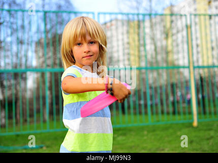 Smiling boy throwing the disk in the park Stock Photo