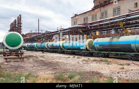 Filling chemicals railroad cars tanks on the plant. Focus on the center of the frame Stock Photo