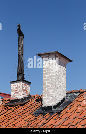 Two older chimneys on a rooftop. Stock Photo