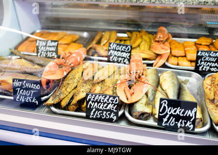 A selection of smoked fish and seafood on display in a refrigerator at The Cley Smokehouse Fresh Fish market in Cley, Norfolk, UK. Stock Photo