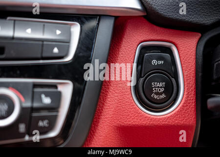 Close-up, isolated image of an engine Start Stop button seen on the dashboard of a german manufactured sports car. Stock Photo