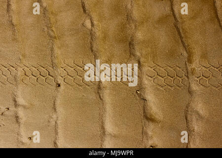 The wheel is stamped on the sand. Stock Photo