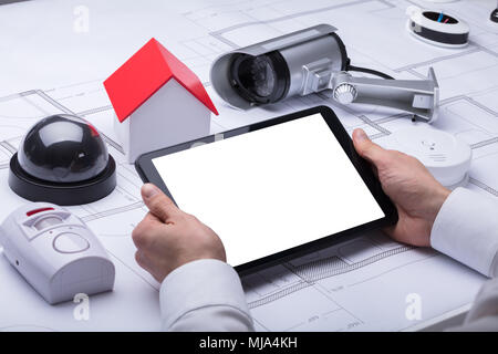 Architect's Hand Using Digital Tablet With Blank White Screen Stock Photo