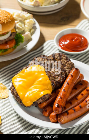Memorial Day Backyard Babecue Meal with Hamburgers Hot dogs Salads and Chips