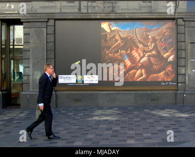 businessman on mobile phone walking on sauchiehall street in front of a representation of general custers last stand, references phone conversation Stock Photo