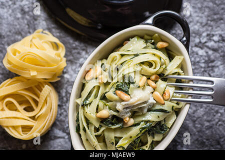Pasta with Green Spinach, Pine Nuts and Gorgonzola Cheese Stock Photo