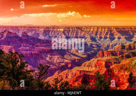 Colorful sunrise over the Grand Canyon, with orange sky, shades of purple, blue red and orange in the canyon. Stock Photo