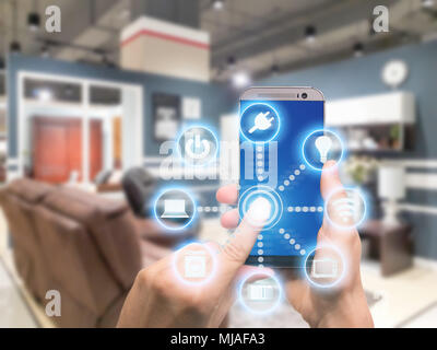 Smart home automation app on mobile with home interior in background. Internet of things concept at home. Smart technology 4.0 Stock Photo