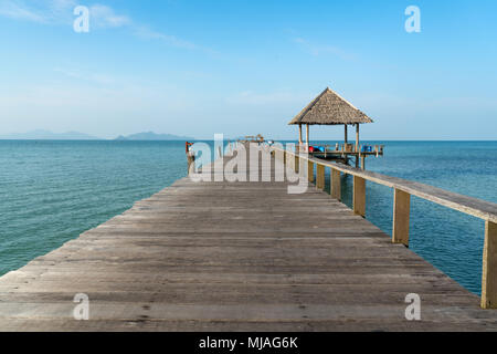 Wooden pier between sunset in Phuket, Thailand. Summer, Travel, Vacation and Holiday concept. Stock Photo