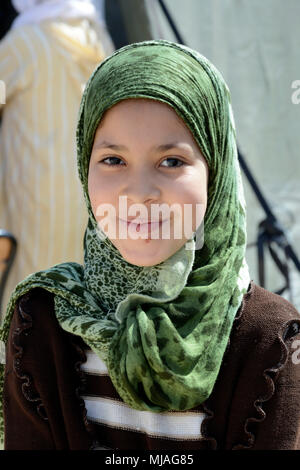 A young girl poses for a photo while waiting for medical care during the Humanitarian Civic Assistance component of Exercise African Lion 2018 in Bounaamane, Morocco, April 22, 2018. Exercise African Lion 2018 is a Chairman of the Joint Chiefs of Staff-sponsored, U.S. Africa Command-scheduled, U.S. Marine Corps Forces Europe and Africa-led, joint and combined exercise conducted in the Kingdom of Morocco. African Lion offers an opportunity to improve interoperability and cooperation while demonstrating the strong military bond that exists between the participating nations. (U.S. Air National Gu Stock Photo