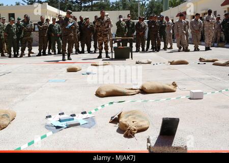 Members of multinational armed forces participate in a Rehearsal of Concept (ROC) drill as part of Exercise African Lion 2018 in Southern Zone Headquarters, Agadir, Morocco, April 21, 2018. A map is laid out on the ground to use the space to visualize a plan of attack. Participating forces include members of the armed forces of Morocco, United States, Canada, Tunisia, United Kingdom, Chad, Senegal, Egypt, Mauritania, Burkina Faso, France, Italy, Greece, Spain, and Mali. (U.S. Marine Corps photo by Sgt. Averi Coppa/Released) Stock Photo