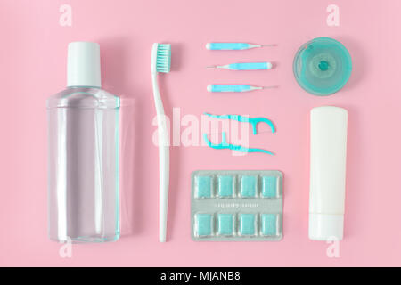 Toothbrushes, toothpaste, rinse and chewing gum set on pink background. Dental and healthcare concept. Free copy space. Stock Photo