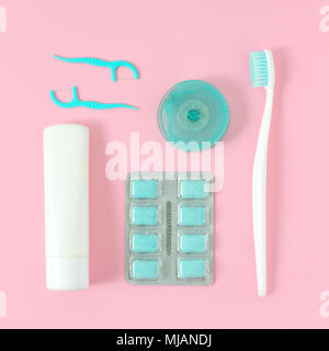 Toothbrushes, toothpaste, and chewing gum set on pink background. Dental and healthcare concept. Free copy space. Stock Photo