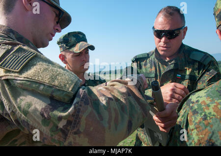 Spc. Christian Portinga (left), the battalion small unmanned aircraft system (sUAS) master trainer assigned to Headquarters and Headquarters Company, 1st Battalion, 18th Infantry Regiment, 2nd Armored Brigade Combat Team, 1st Infantry Division, Fort Riley, Kansas, helps prepare a RQ-11B Raven Unmanned Aircraft System (UAS) with Bulgarian soldiers assigned to the (UAS) platoon from I STAR Battalion, 61st Mechanized Brigade, Kazanlak, Bulgaria, April 26, 2018, in Kazanlak, Bulgaria. (U.S. Army photo by Spc. Jacob Banuelos / 22nd Mobile Public Affairs Detachment)  Stock Photo