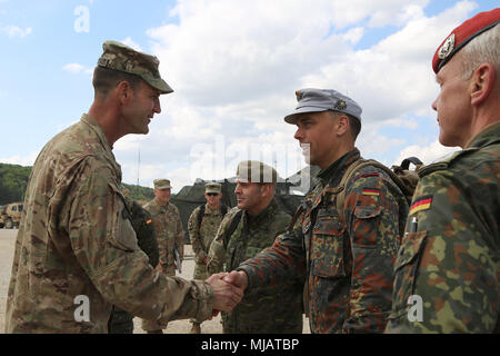 Col. James Bartholomees, commander of 173rd Infantry Brigade Combat Team (Airborne), greets multinational distinguished visitors, Hohenfels, Germany, April 26, 2018. Various military and civilian officials came to Hohenfels to see how the Joint Warfighting Assessment (JWA) helps the Army evaluate emerging concepts, integrate new technologies, and promote interoperability within the Army, with the other services, U.S. allies, and partners.  (U.S. Army photo by Staff Sgt. Kalie Frantz) Stock Photo