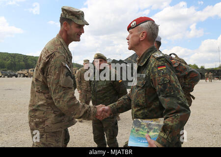 Col. James Bartholomees, commander of 173rd Infantry Brigade Combat Team (Airborne), greets multinational distinguished visitors, Hohenfels, Germany, April 26, 2018. Various military and civilian officials came to Hohenfels to see how the Joint Warfighting Assessment (JWA) helps the Army evaluate emerging concepts, integrate new technologies, and promote interoperability within the Army, with the other services, U.S. allies, and partners.  (U.S. Army photo by Staff Sgt. Kalie Frantz) Stock Photo