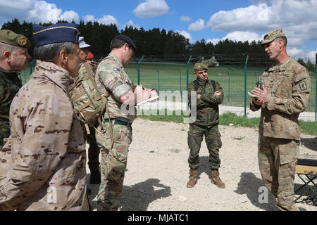 Col. James Bartholomees, commander of 173rd Infantry Brigade Combat Team (Airborne), briefs multinational distinguished visitors, Hohenfels, Germany, April 26, 2018. Various military and civilian officials came to Hohenfels to see how the Joint Warfighting Assessment (JWA) helps the Army evaluate emerging concepts, integrate new technologies, and promote interoperability within the Army, with the other services, U.S. allies, and partners.  (U.S. Army photo by Staff Sgt. Kalie Frantz) Stock Photo