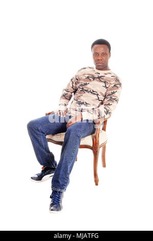 A full body image of a African American man in jeans and t-shirt sitting on chair and relaxing, isolated for white background Stock Photo