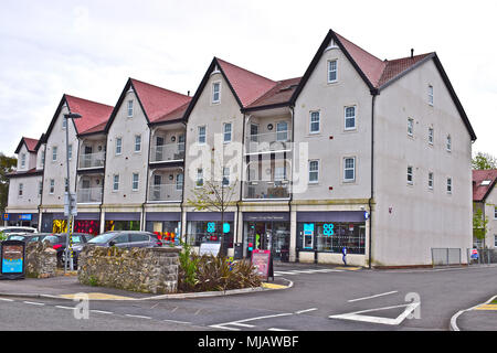 A newly completed block of modern flats with retail premises on ground floor, occupied by the Coop and Greggs the bakery. New Road, Porthcawl,S.wales Stock Photo