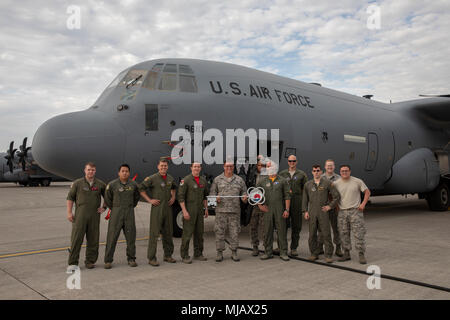 Members of the C-130J Super Hercules number 8610 delivery team pose for a photo at Yokota Air Base, Japan, April 27, 2018. This is the thirteenth C-130J delivered from Ramstein Air Base, and completed its C-130J fleet. (U.S. Air Force photo by Yasuo Osakabe) Stock Photo