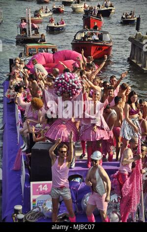 Amsterdam, Netherlands - August 1, 2015: Party people in pink costumes dancing on a boat at the traditional gay pride canal cruise Stock Photo