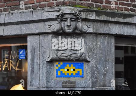 Amsterdam, Netherlands - January 4, 2018: Space Invader mosaic tile street art on the corner of the Keizersgracht and Berenstraat Stock Photo